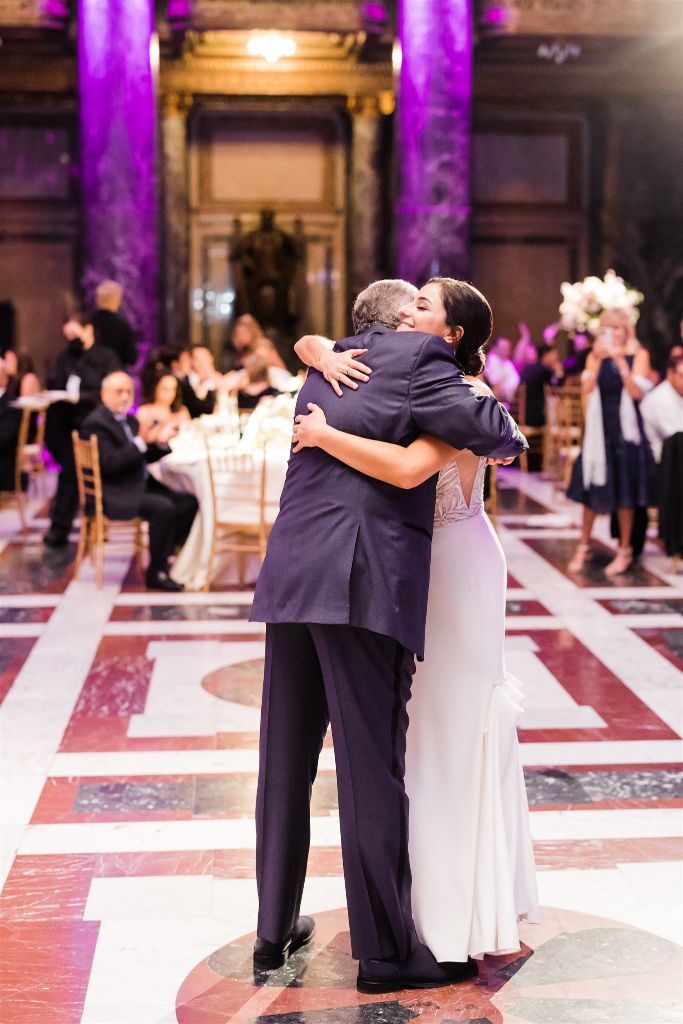Bride and father embrace after sharing dance