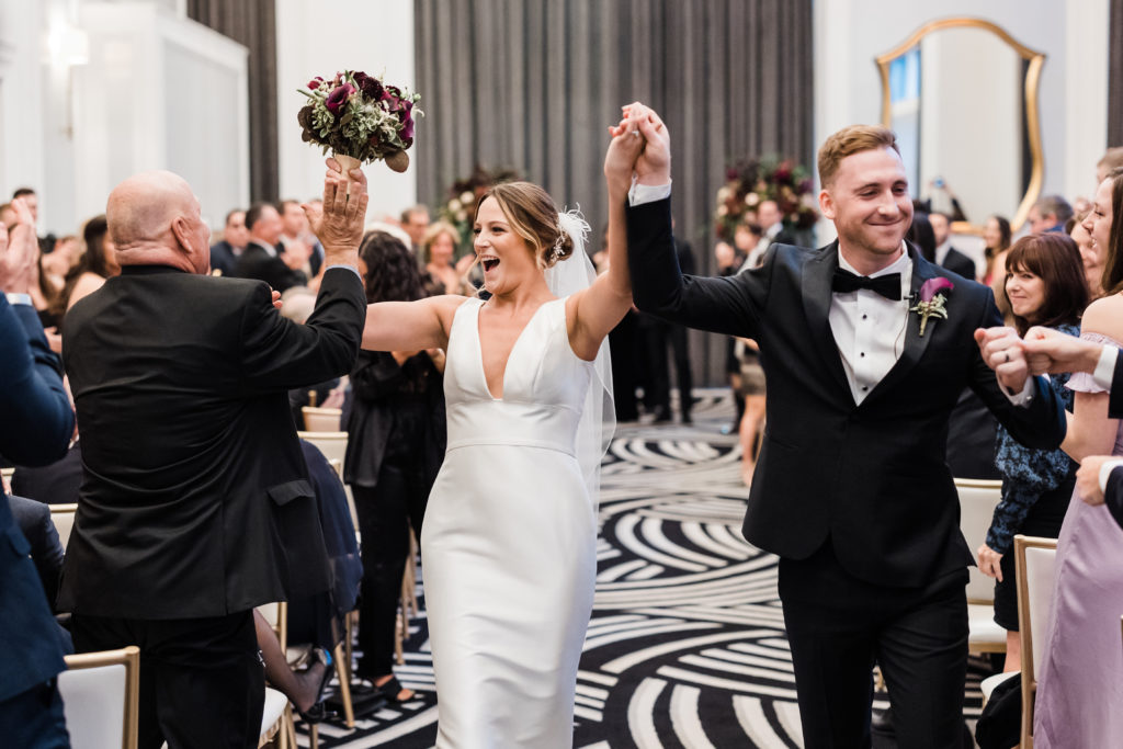 Bride and groom celebrate walking down the aisle at Wedding at Hotel Monaco