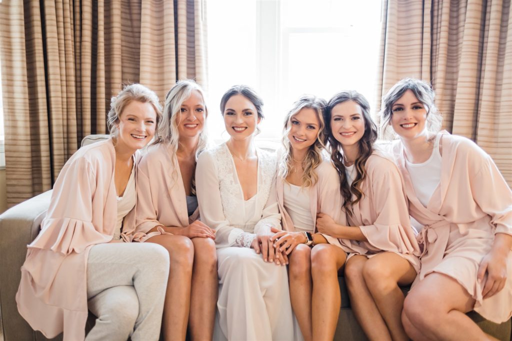 Bride with bridesmaids in blush colored robes