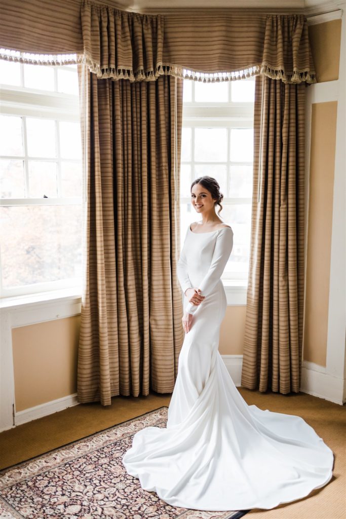 Bride stands in stunning white down at Mansions on Fifth