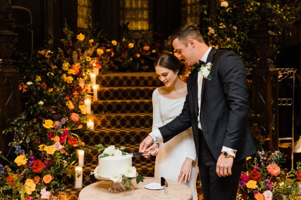 Bride and groom cut their wedding cake at their Mansions on Fifth wedding
