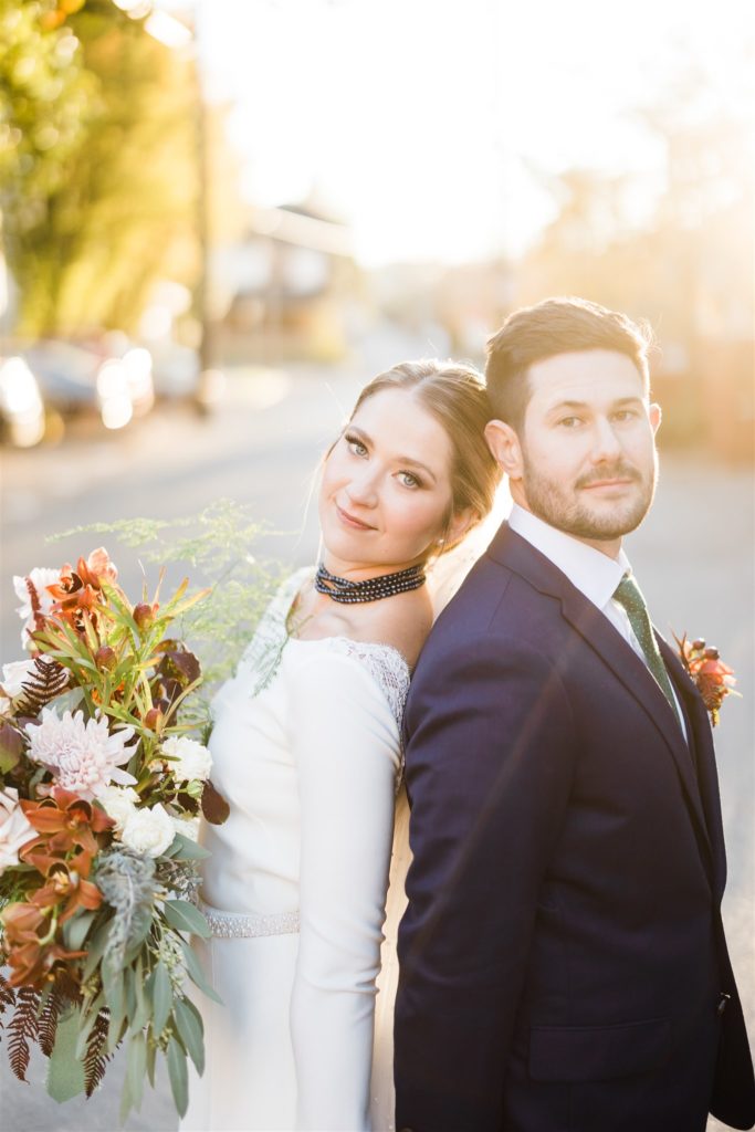 Bride and groom pose at Graduate Hotel fall wedding