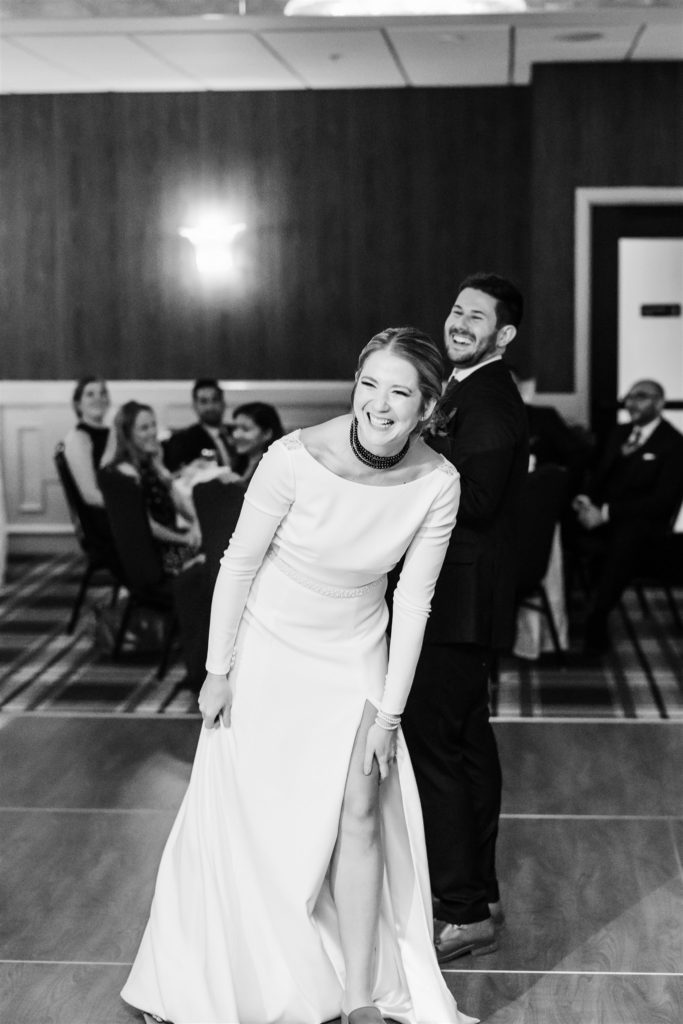 Bride and groom laugh on the dance floor of Graduate Hotel wedding 