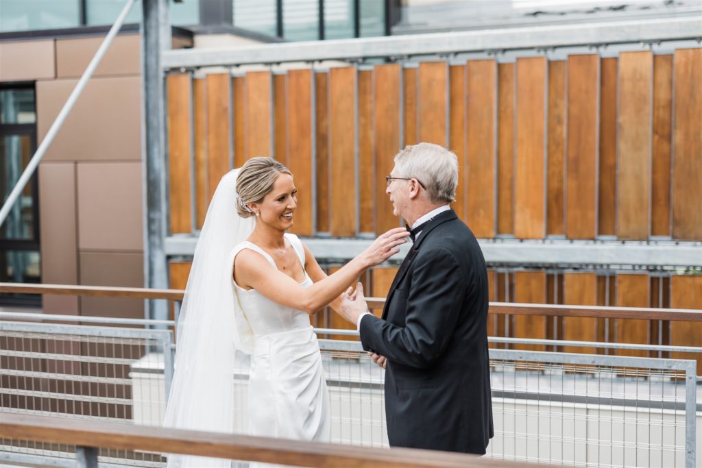 bride and her father interact sweetly as they see each other for the first time