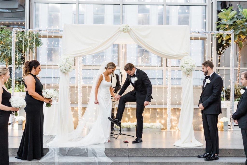 Groom crushes glass with his foot at end of Black and White PPG Wedding