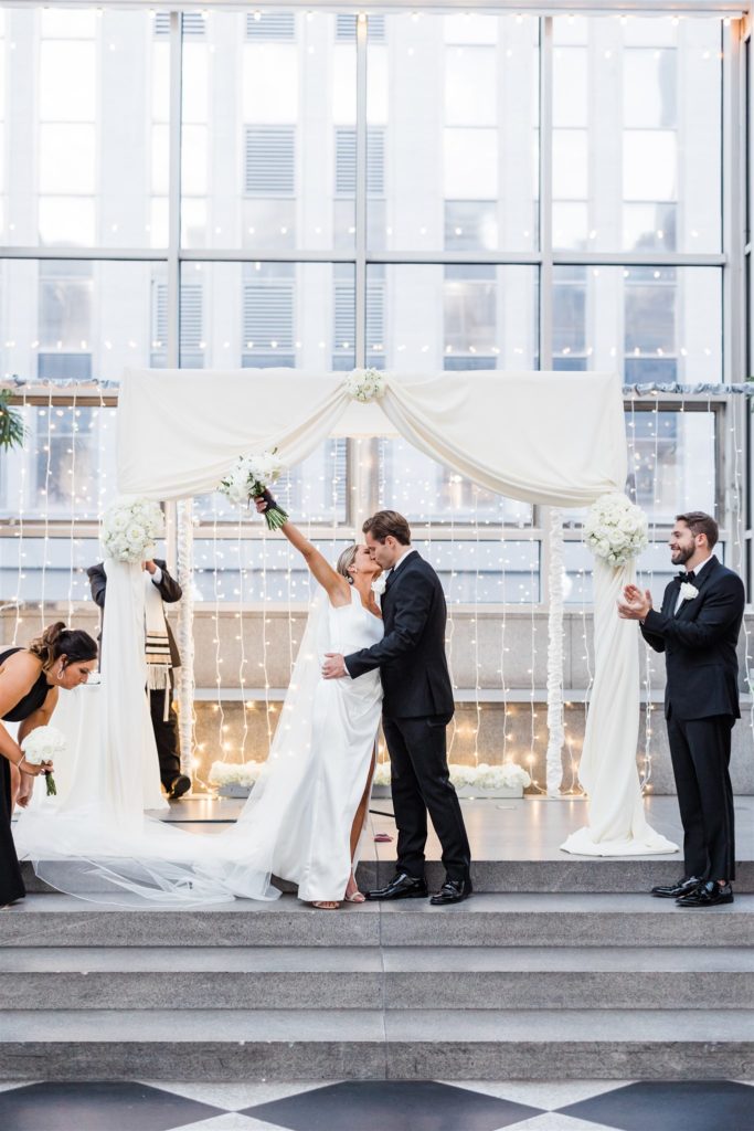 Bride and groom share first kiss at Black and White PPG Wedding