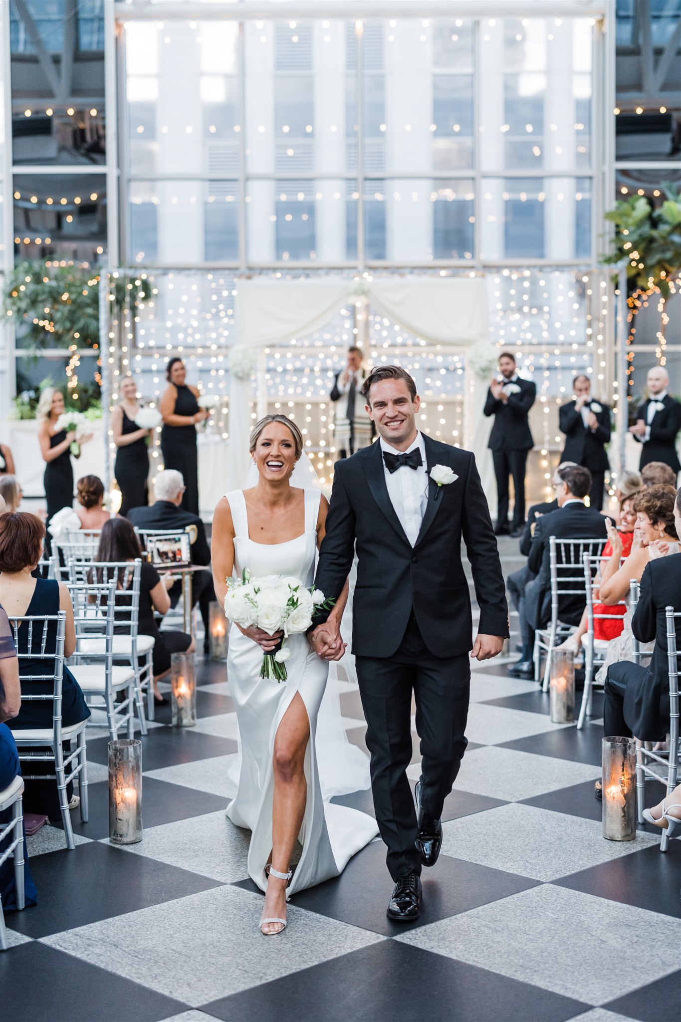 bride and groom walk up the aisle together after saying 'I Do' at Black and White PPG Wedding