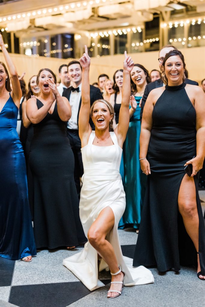 Bride dances and celebrates as groom plays surprise song at black and white PPG wedding