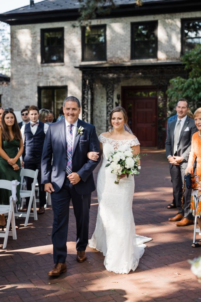 Bride and father walk down the aisle together at Wedding at Succop Conservancy