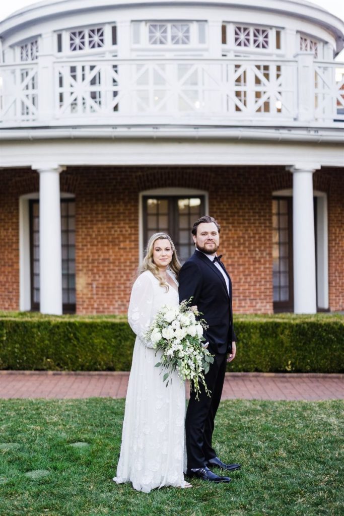 Bride and groom pose together in front of Bedford Springs Resort wedding