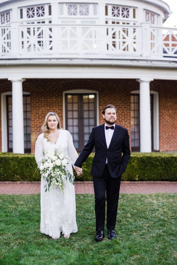 Bride and groom pose together in front of Bedford Springs Resort wedding