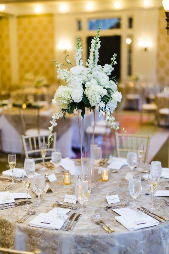 High white centerpiece with hydrangeas, roses and greenery