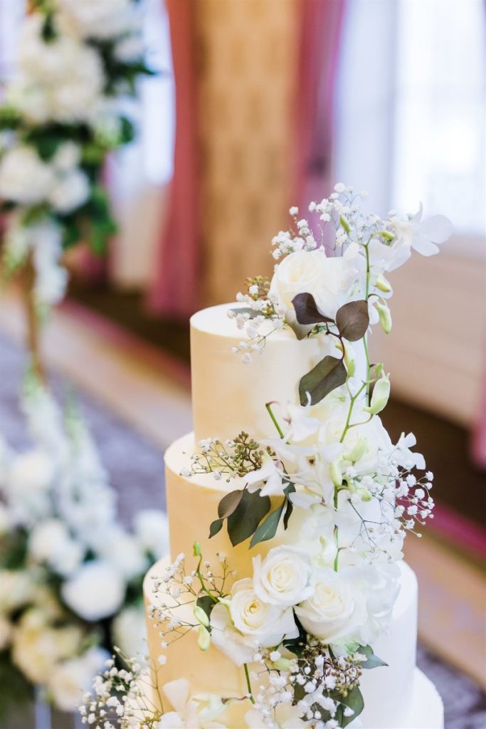 All white cake adorned with white fresh florals