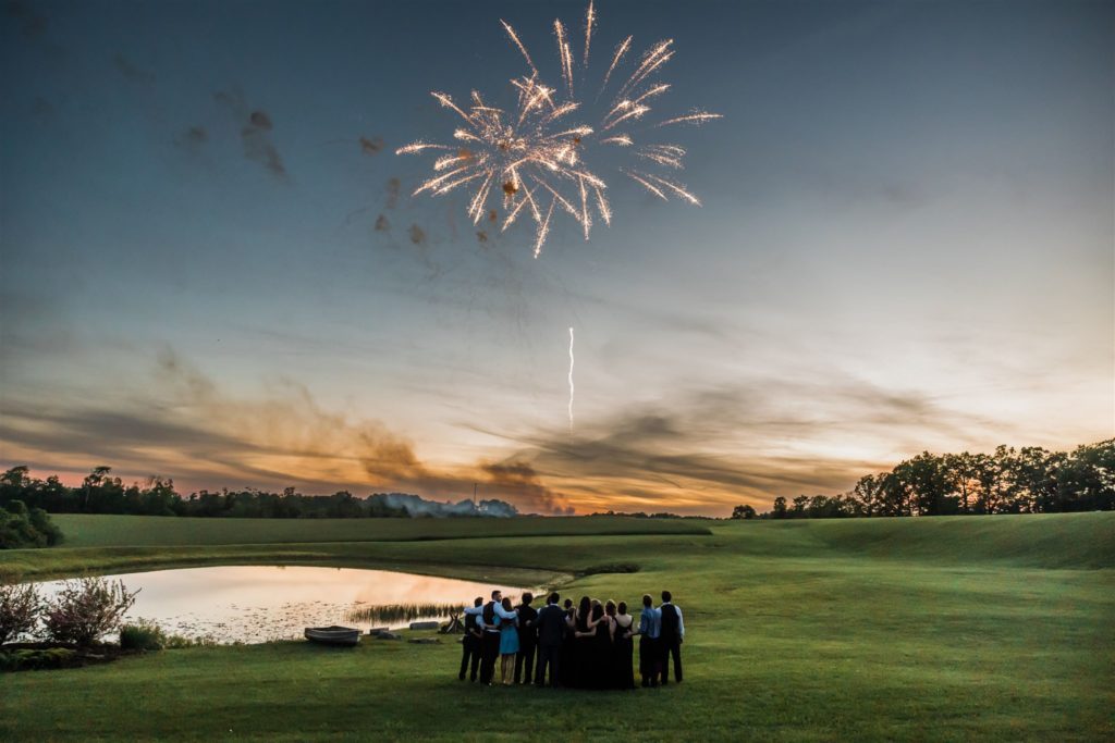 Weddings guests watch fireworks outside the White Barn