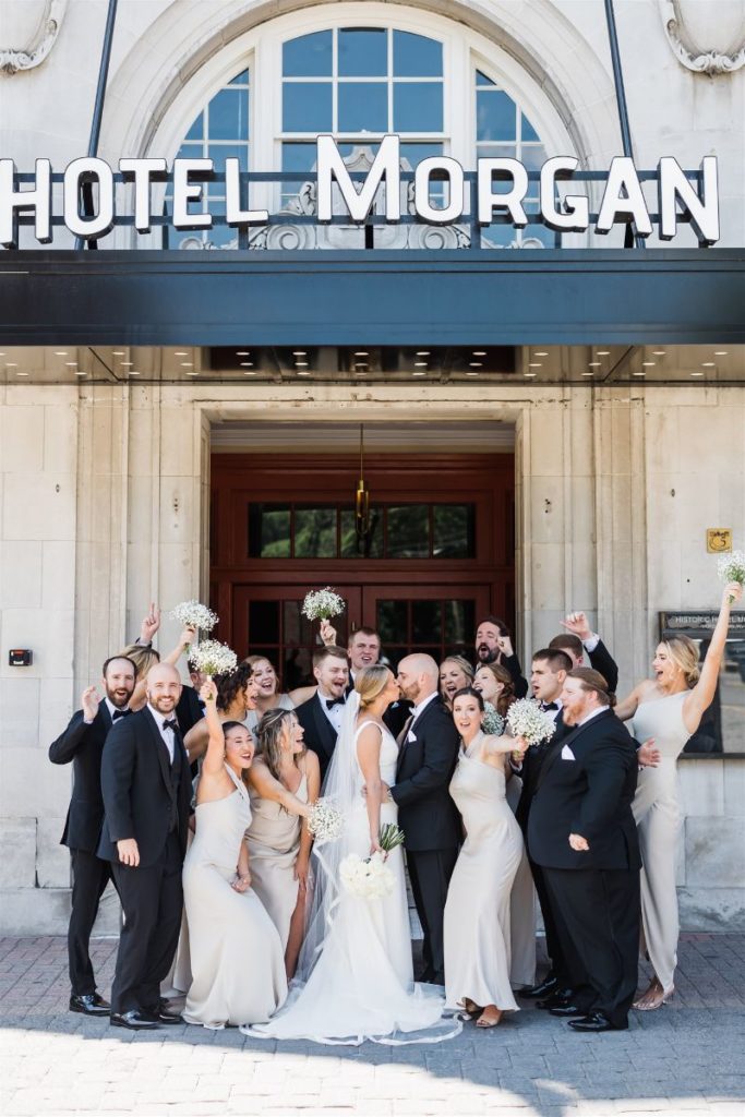 Bridal party celebrates in front of Hotel Morgan