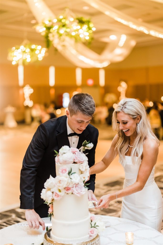 Bride and groom cut the cake at their Erie Bayfront Center Wedding reception