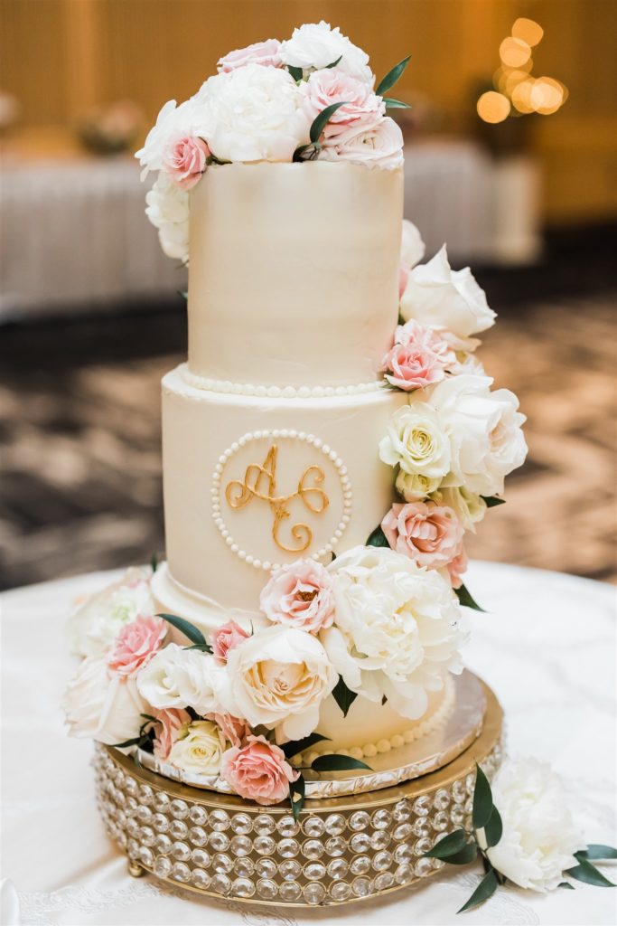 White, blush and gold three tiered wedding cake