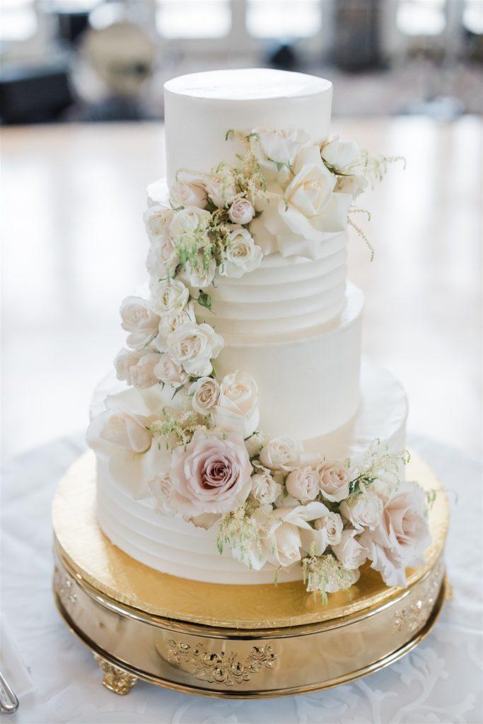 All white wedding cake with pink and white florals